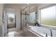Bathroom features a large bathtub with window, separate tiled shower and linen closet with natural light at 7055 Nc-242, Dunn, NC 28334