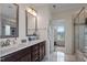 Bathroom with double vanity, white marble countertops, and tile flooring with a view to a sunlit bonus room at 7055 Nc-242, Dunn, NC 28334