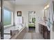 Bright bathroom featuring a soaking tub, shower and vanity, with natural light from the nearby window at 7055 Nc-242, Dunn, NC 28334