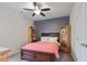 Comfortable bedroom with hardwood bed frame and floors and a large ceiling fan at 7055 Nc-242, Dunn, NC 28334