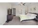 Spacious primary bedroom featuring a ceiling fan, dresser with TV, and ensuite bathroom access at 7055 Nc-242, Dunn, NC 28334