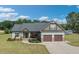 Charming two-story home featuring a two-car garage, manicured lawn, and inviting front porch at 7055 Nc-242, Dunn, NC 28334