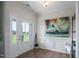 Bright foyer with hardwood floors, modern artwork, and a view of the front yard at 7055 Nc-242, Dunn, NC 28334