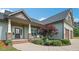 Inviting front porch featuring stone accents, well-kept landscaping, and seating area at 7055 Nc-242, Dunn, NC 28334