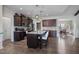 Granite island with seating and pendant lights highlights this modern kitchen at 7055 Nc-242, Dunn, NC 28334
