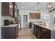 Modern kitchen with dark wood cabinets, stainless steel appliances, and granite countertops at 7055 Nc-242, Dunn, NC 28334
