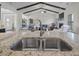 Open kitchen with island, stainless steel sink, and view of living area with a fireplace at 7055 Nc-242, Dunn, NC 28334