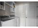 The laundry room features modern appliances and functional built-in shelving at 7055 Nc-242, Dunn, NC 28334