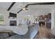 Open-concept living area with vaulted ceiling, fireplace, and hardwood floors adjacent to the modern kitchen at 7055 Nc-242, Dunn, NC 28334