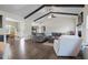 Spacious living room featuring a fireplace, vaulted ceiling with wooden beams, and hardwood floors at 7055 Nc-242, Dunn, NC 28334