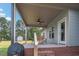 Inviting outdoor patio featuring a ceiling fan, dining set, and a grilling area at 7055 Nc-242, Dunn, NC 28334