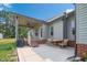 Charming home featuring a covered patio and well-maintained lawn at 7055 Nc-242, Dunn, NC 28334