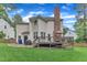 A backyard features a deck with umbrella table set, grassy lawn and partial privacy fence at 7613 Percy Ct, Raleigh, NC 27613