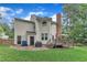 A backyard features a deck with umbrella table set, grassy lawn and partial privacy fence at 7613 Percy Ct, Raleigh, NC 27613