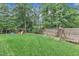Fenced backyard with a wooden deck, stone ground cover and a swing set at 7613 Percy Ct, Raleigh, NC 27613