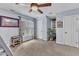 Spacious bedroom with neutral carpet, large window, a potted plant, and decorations at 7613 Percy Ct, Raleigh, NC 27613