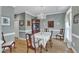 Elegant dining room with a classic chandelier, hardwood floors, and neutral paint at 7613 Percy Ct, Raleigh, NC 27613