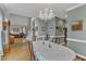 Dining area with chandelier, leading to living room and staircase with hardwood floors at 7613 Percy Ct, Raleigh, NC 27613