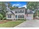 Inviting two-story home with lush lawn, attached garage, and classic black shutters at 7613 Percy Ct, Raleigh, NC 27613