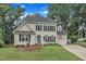 Charming two-story home with manicured lawn, brick-lined driveway, and inviting curb appeal at 7613 Percy Ct, Raleigh, NC 27613