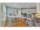 Bright kitchen featuring an eat-in area with a white table, hardwood floors, and plenty of natural light at 7613 Percy Ct, Raleigh, NC 27613