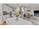 Bright kitchen featuring an eat-in area, bar stools, and open access to the living area at 7613 Percy Ct, Raleigh, NC 27613