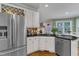 Updated kitchen featuring granite countertops, stainless appliances, tile backsplash, and white cabinets at 7613 Percy Ct, Raleigh, NC 27613
