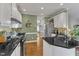 Updated kitchen with granite countertops, a tile backsplash, stainless steel appliances, and white cabinets at 7613 Percy Ct, Raleigh, NC 27613