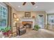 Cozy living room featuring a brick fireplace, comfortable seating and bright natural light at 7613 Percy Ct, Raleigh, NC 27613