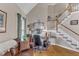 Cozy home office area with hardwood floors, staircase, and warm natural light at 7613 Percy Ct, Raleigh, NC 27613