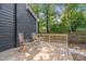 Spacious wooden deck with chairs, and a view of the lush fenced backyard at 924 W Trinity Ave, Durham, NC 27701