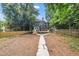 Backyard view of a charming black home with a wooden fence, deck, and a spacious yard at 924 W Trinity Ave, Durham, NC 27701