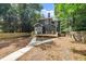 Backyard view of a charming black home with a wooden fence, deck, and a spacious yard at 924 W Trinity Ave, Durham, NC 27701