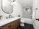 Bathroom boasts stylish vanity, sleek fixtures, geometric tile accent wall, and shower-over-tub design at 924 W Trinity Ave, Durham, NC 27701