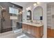 Elegant bathroom featuring a double vanity, walk-in shower, and stylish tile flooring at 924 W Trinity Ave, Durham, NC 27701