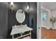 Stylish powder room with marble countertop, designer fixtures, and elegant oval mirror at 924 W Trinity Ave, Durham, NC 27701