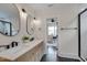 Bright bathroom featuring double sinks, modern fixtures, and an adjacent shower with glass door at 924 W Trinity Ave, Durham, NC 27701