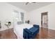 Cozy bedroom features a bed, and a blue bench with ample natural light from the windows at 924 W Trinity Ave, Durham, NC 27701