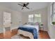 Comfortable bedroom featuring a ceiling fan, natural light, and hardwood flooring at 924 W Trinity Ave, Durham, NC 27701