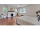 Sunlit bedroom featuring a white fireplace, hardwood floors and large windows at 924 W Trinity Ave, Durham, NC 27701