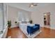 Bright bedroom with hardwood floors and a large window for natural lighting at 924 W Trinity Ave, Durham, NC 27701