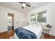 Sunlit bedroom featuring hardwood floors, a ceiling fan, closet and a comfortable bed with a cozy blanket at 924 W Trinity Ave, Durham, NC 27701