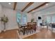 Dining area featuring hardwood floors, exposed beams, and a clear view to the living room at 924 W Trinity Ave, Durham, NC 27701