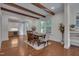 Dining room with hardwood floors, exposed beams, and large windows offering lots of natural light at 924 W Trinity Ave, Durham, NC 27701