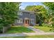 Beautiful two-story home with a gray exterior, manicured lawn, and mature shade trees at 924 W Trinity Ave, Durham, NC 27701