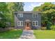 Charming two-story home featuring a stucco facade, brick steps, and a well-manicured lawn at 924 W Trinity Ave, Durham, NC 27701
