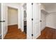 Hallway view showcasing white trim, hardwood floors, and doorways leading to a bathroom and a closet at 924 W Trinity Ave, Durham, NC 27701