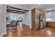Open kitchen and dining area with hardwood floors, stainless steel appliances, and wooden beam architecture at 924 W Trinity Ave, Durham, NC 27701