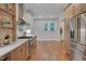 Beautiful kitchen with stainless appliances and custom cabinetry and brick detailing at 924 W Trinity Ave, Durham, NC 27701