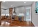 Modern kitchen with stainless steel appliances, custom cabinetry, and hardwood floors at 924 W Trinity Ave, Durham, NC 27701